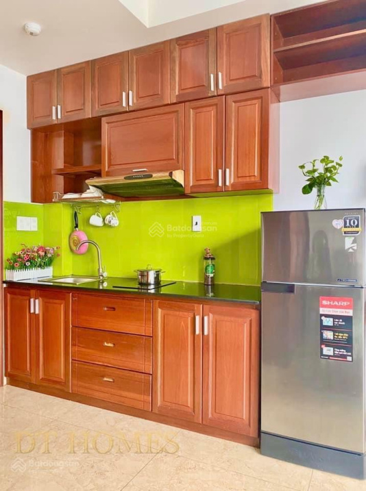 Modern Furnished Studio with Green Kitchen Accents