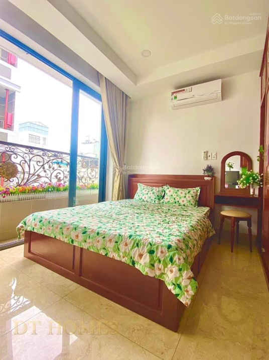 Modern Furnished Studio with Green Kitchen Accents