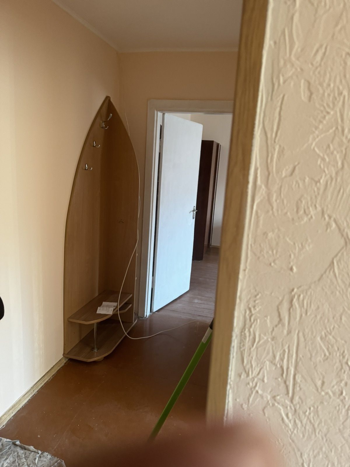 Two separate rooms with furniture, washing machine, and refrigerator