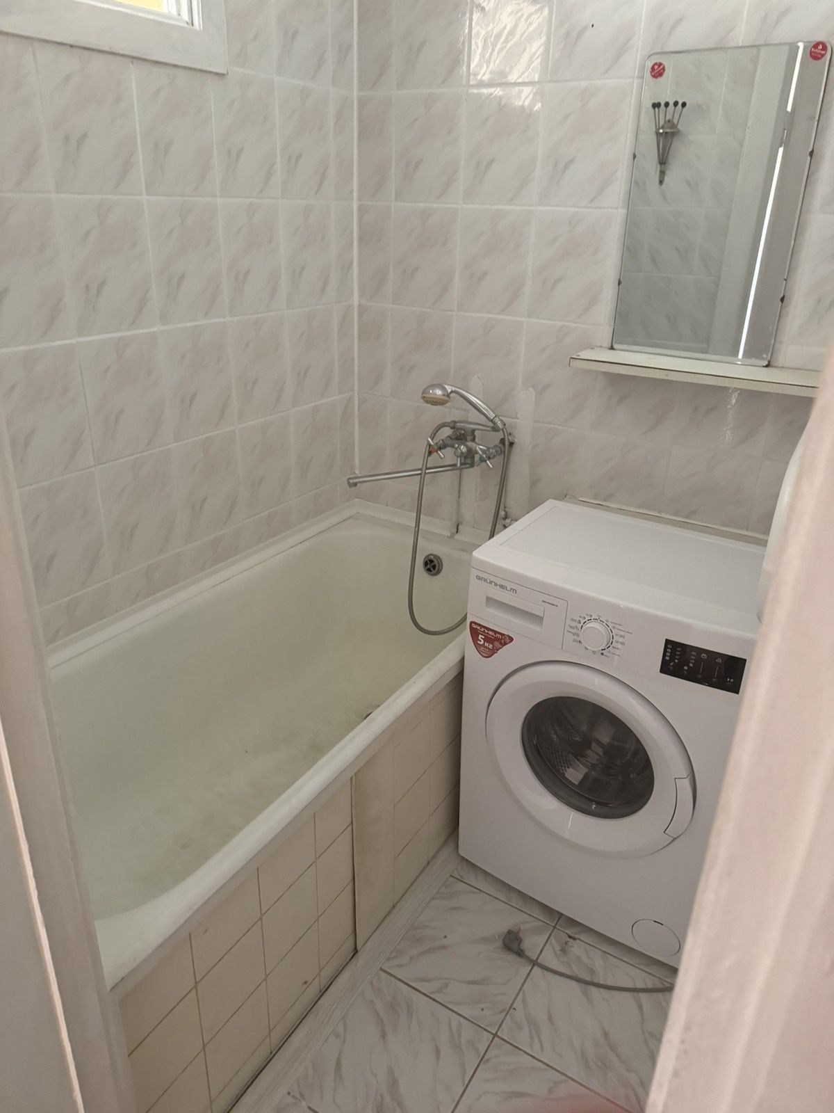Two separate rooms with furniture, washing machine, and refrigerator